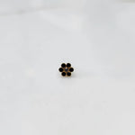Close up nose pin design gold with dark stone floral cluster