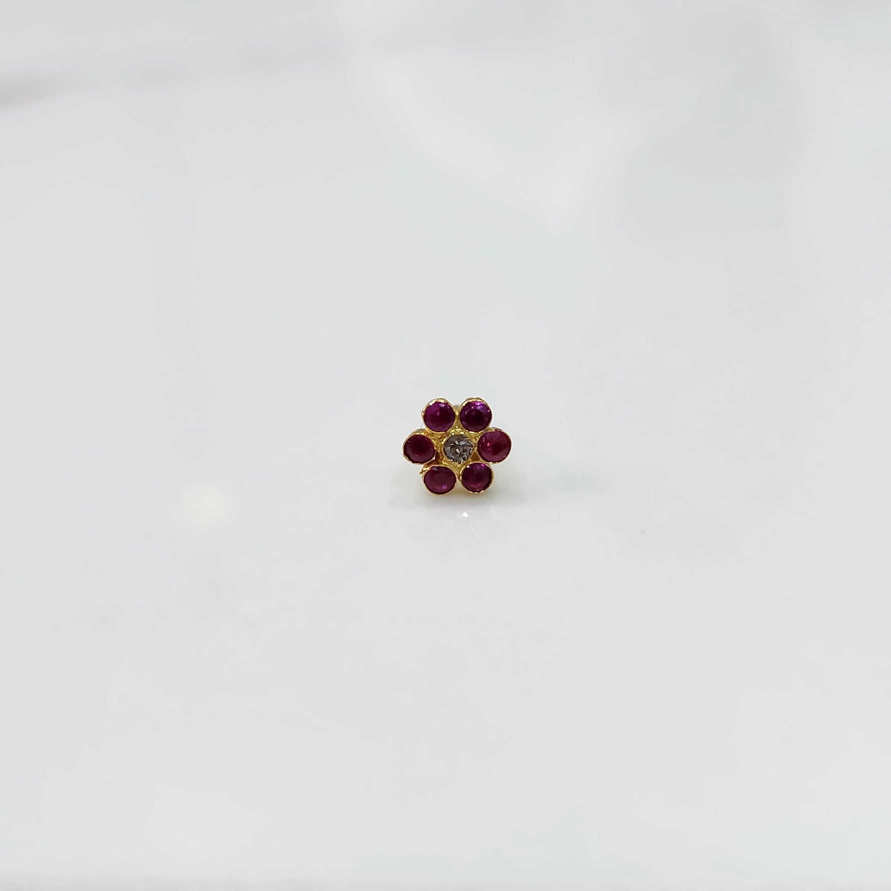 Nose pin design gold with tone floral pattern on white background