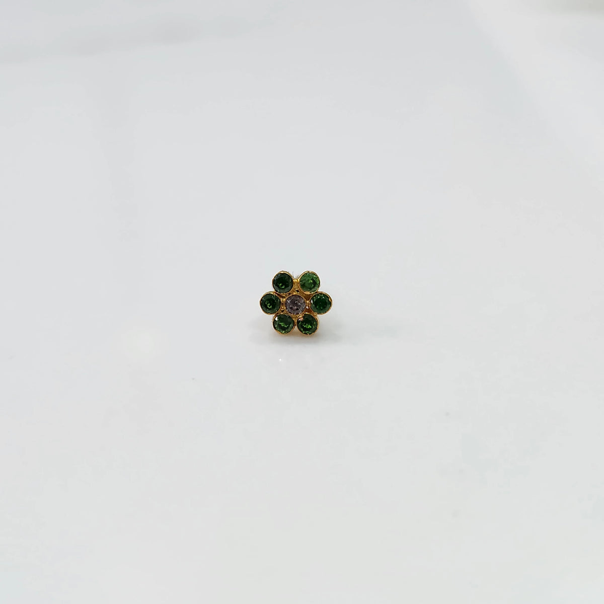 Nose pin design gold with stone floral pattern on white background