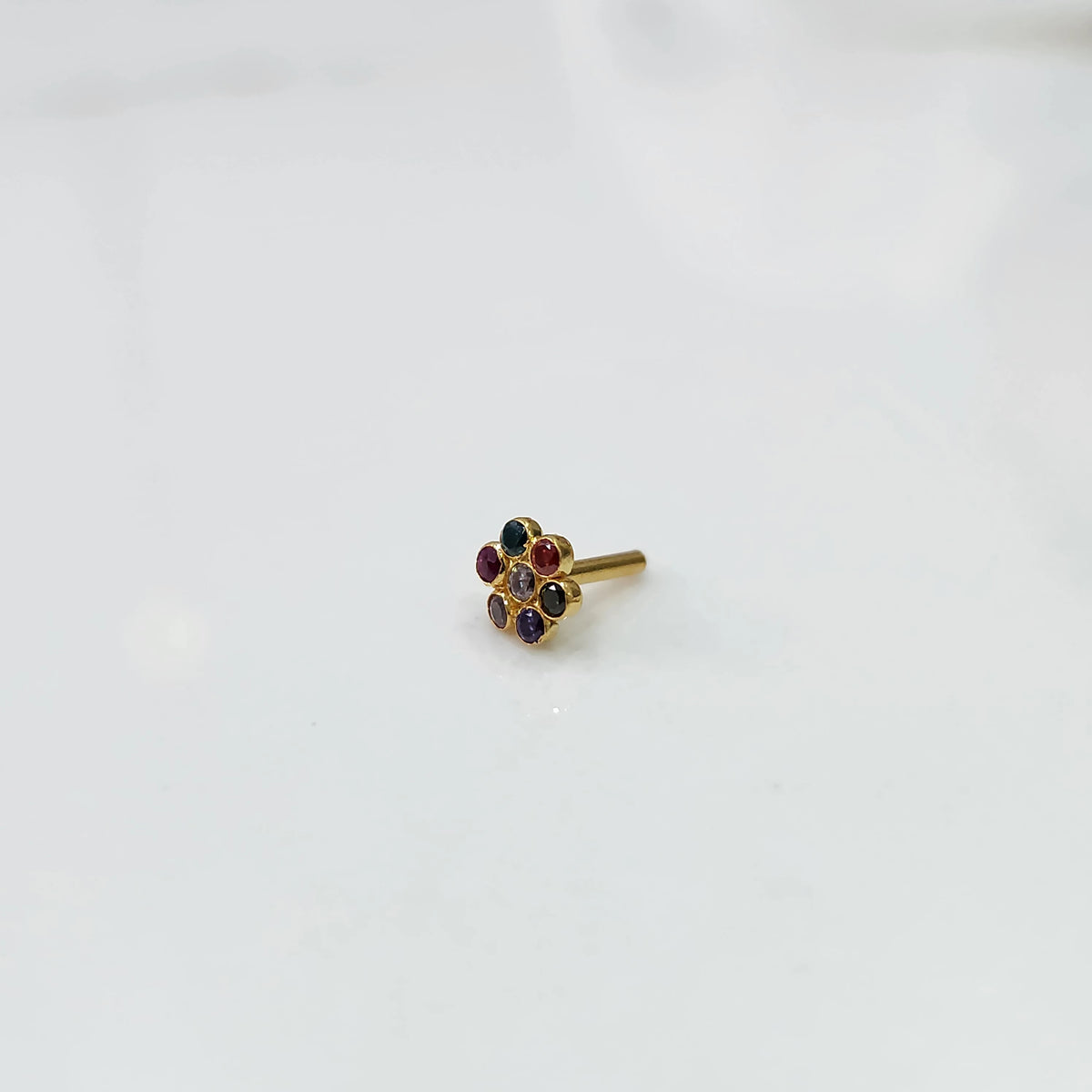 Side view nose pin design gold with floral gemstone setting
