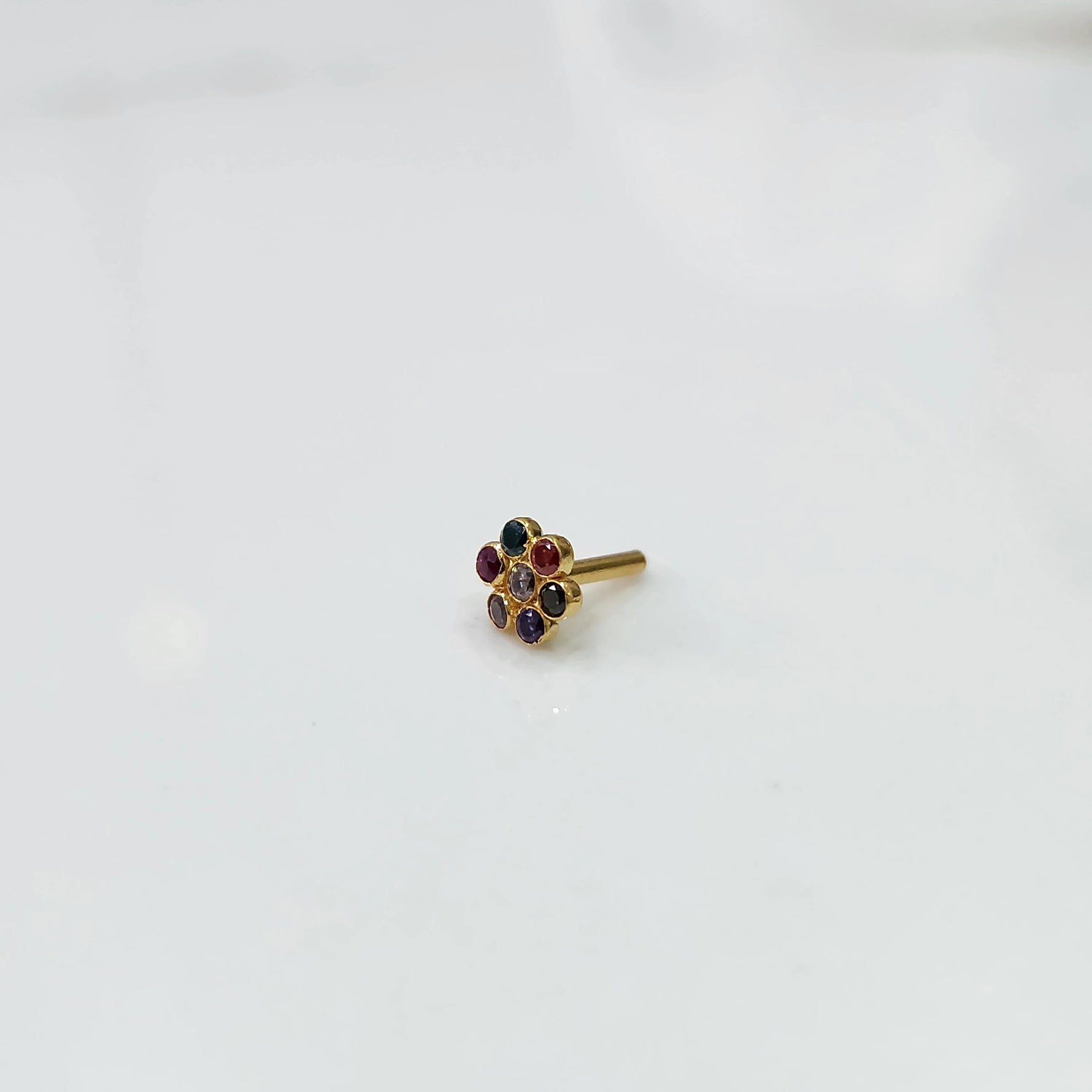 Side view nose pin design gold with floral gemstone setting