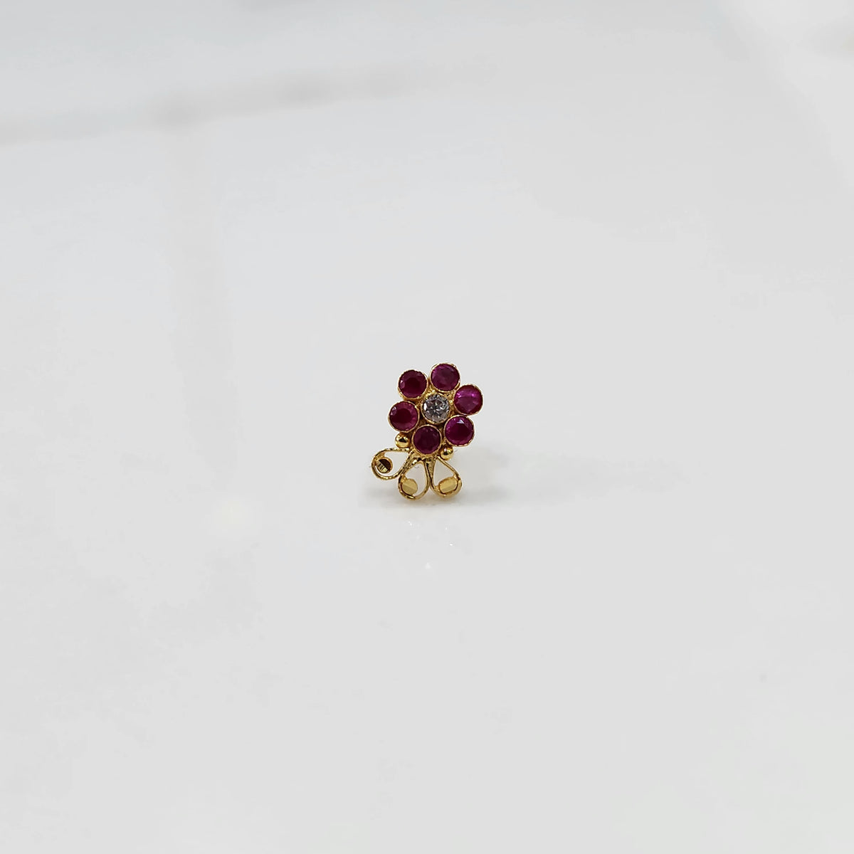 Lab grown diamond nose pin with red stone floral design on white background