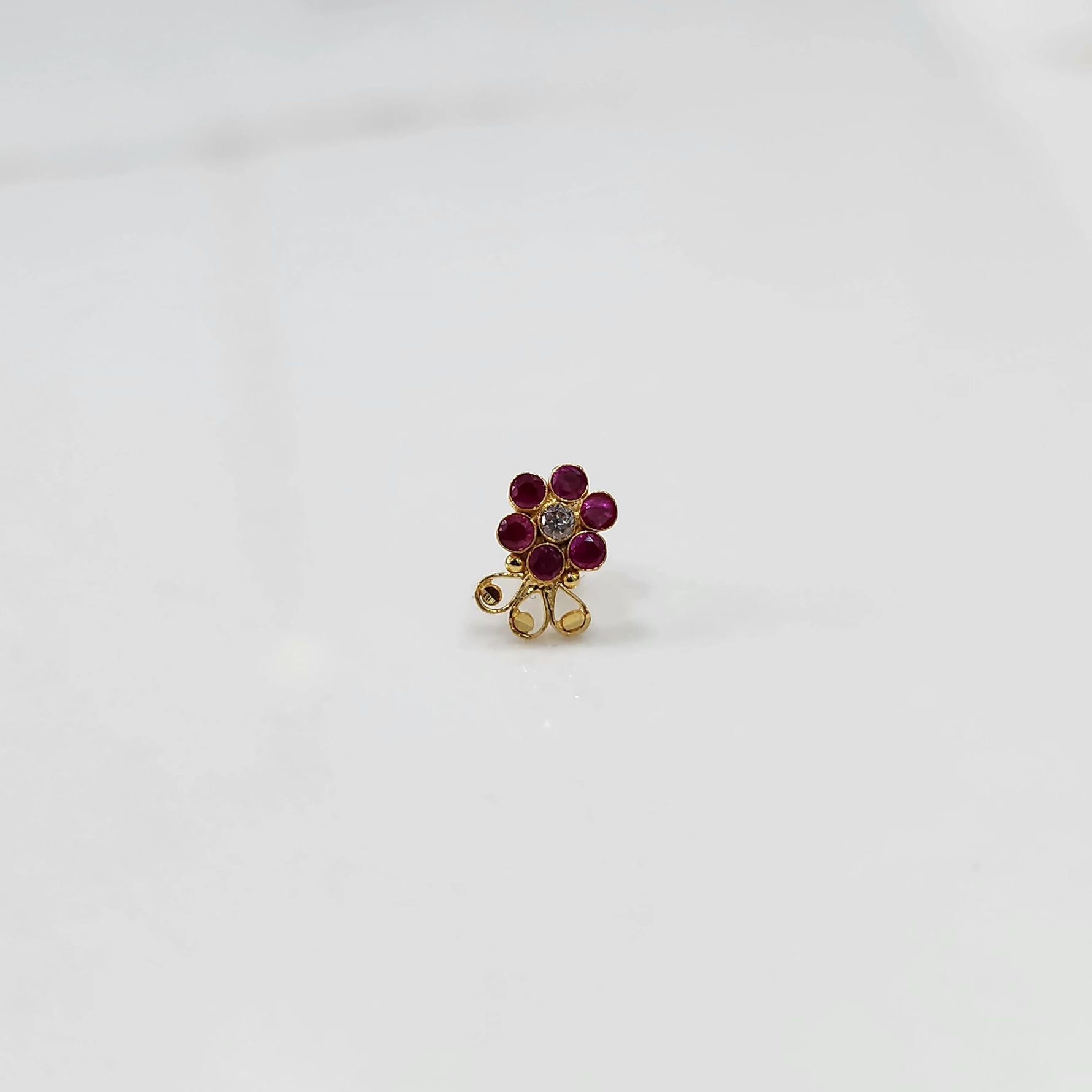 Lab grown diamond nose pin with red stone floral design on white background