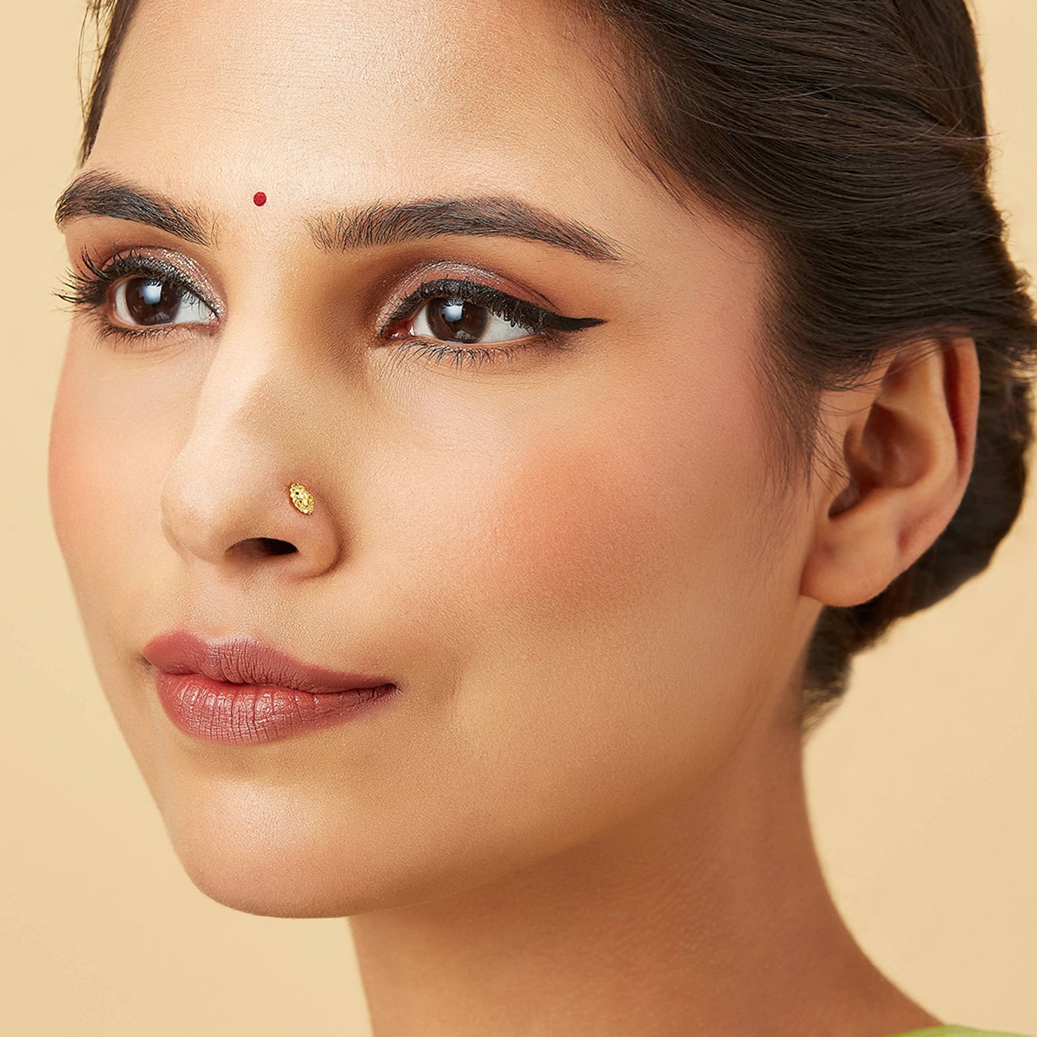 Auric Corona gold nose pin in 18K worn by model, radiant circular sunrise-inspired design jewelry for women