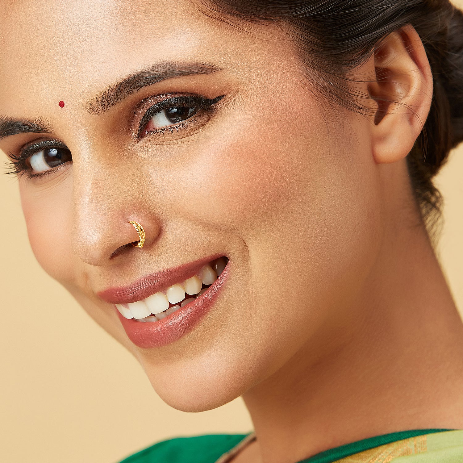 Model wearing Center Loop Gold Nose Ring in 18K gold with geometric loop design, perfect for diamond-shaped face