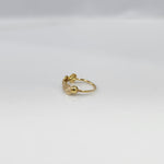 Crossbeam Circles gold nose ring in 18K gold displayed on a flat surface, featuring circular cross patterns with an elegant design