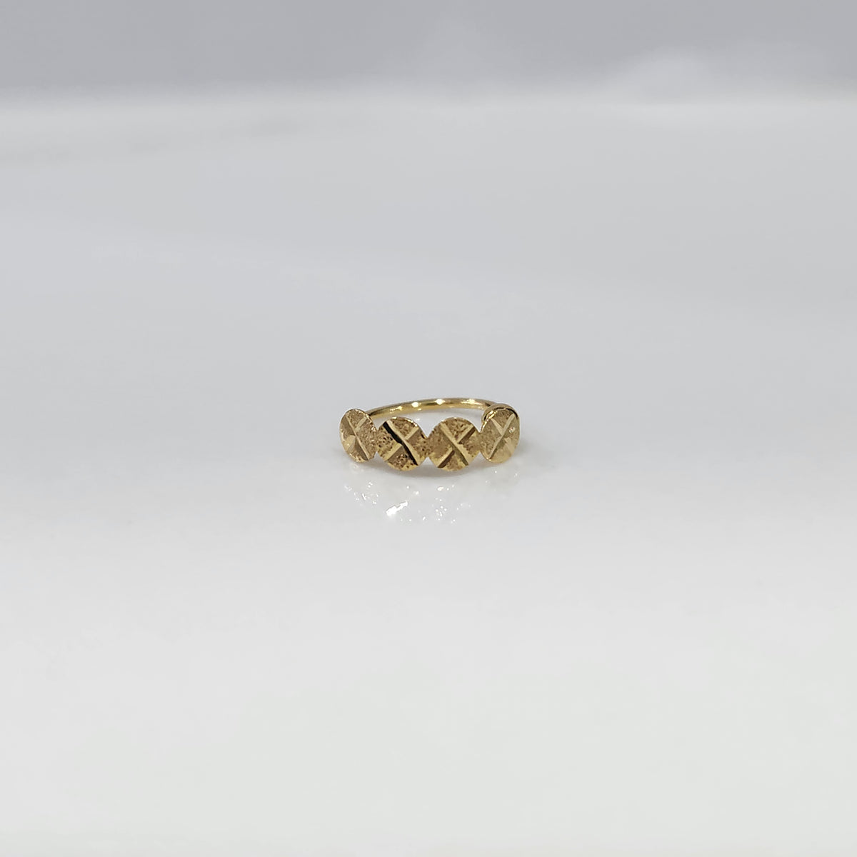 Crossbeam Circles gold nose ring in 18K gold shown in a front flat view, featuring intersecting circular cross patterns with a refined design