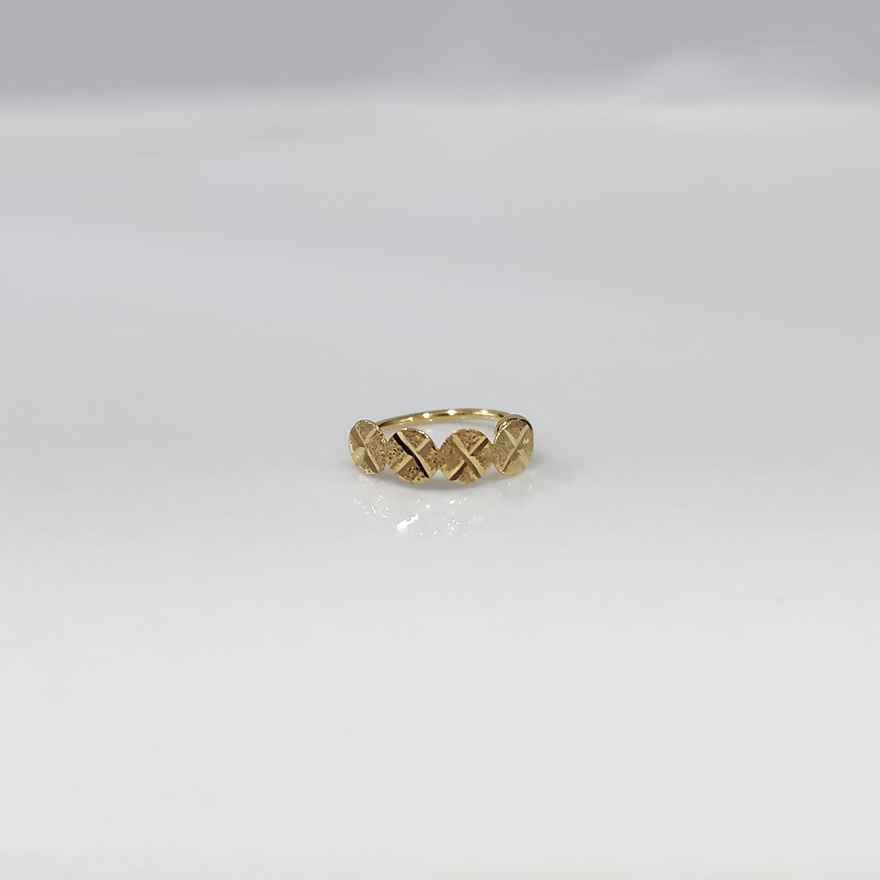 Crossbeam Circles gold nose ring in 18K gold shown in a front flat view, featuring intersecting circular cross patterns with a refined design