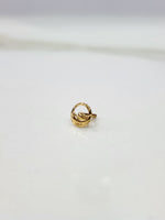 Encircled Waves gold nose pin in 18K gold displayed on a flat surface with elegant wave-inspired circular design