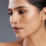 Model wearing Enigma Weave gold nose pin in 18K gold showcasing elegant woven design