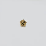 Close-up view of five-petal 18k gold nose pin with intricate floral design, crafted in lightweight gold for daily wear.