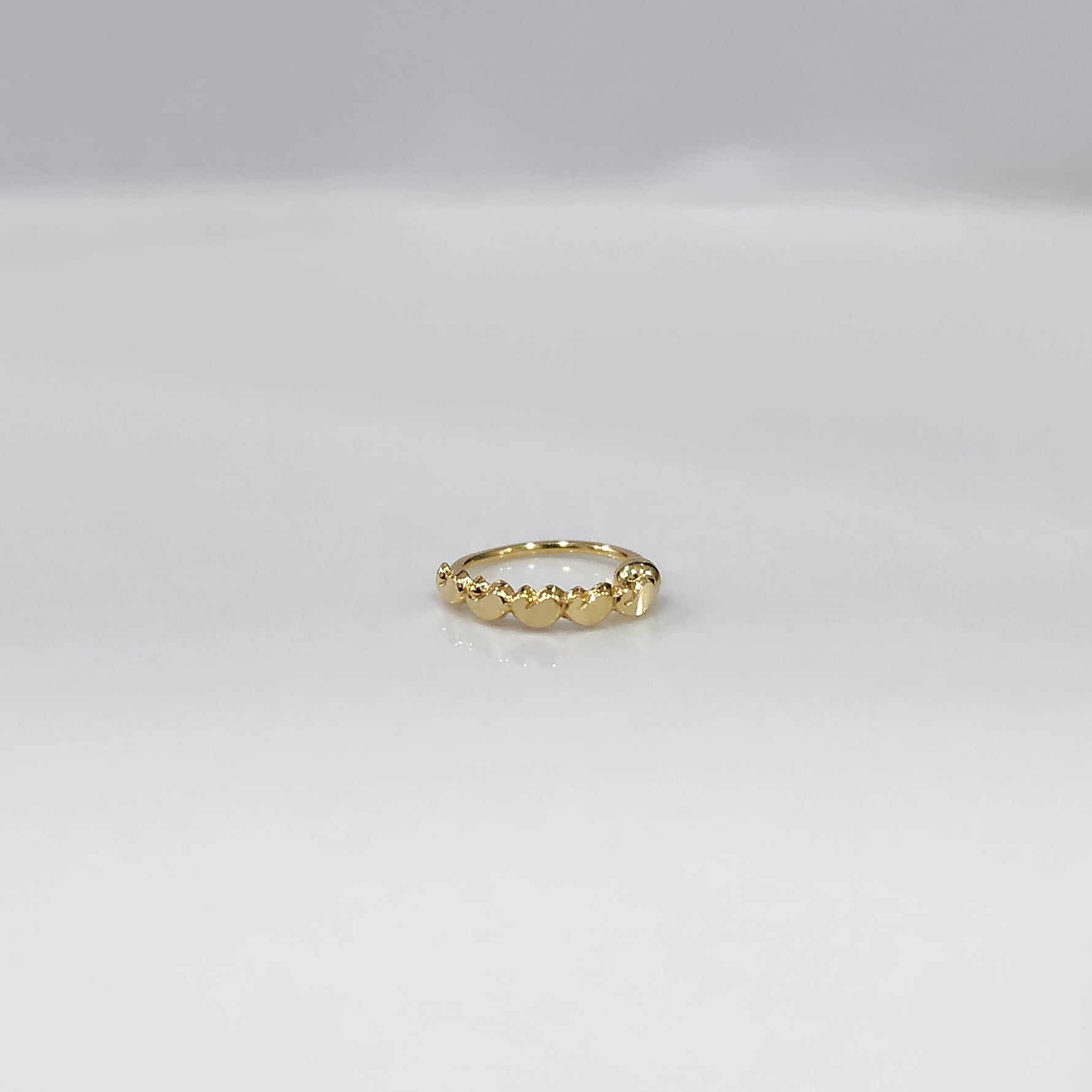 Gold Heart Row gold nose ring with elegant heart pattern design, crafted in 18K gold, displayed on plain background