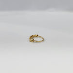 Gold Heart Row gold nose ring in 18K gold with delicate heart pattern, side view on plain background