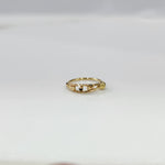 Gold Orbit Gold Nose Ring in 18K gold displayed on a flat surface with intricate orbit-inspired design