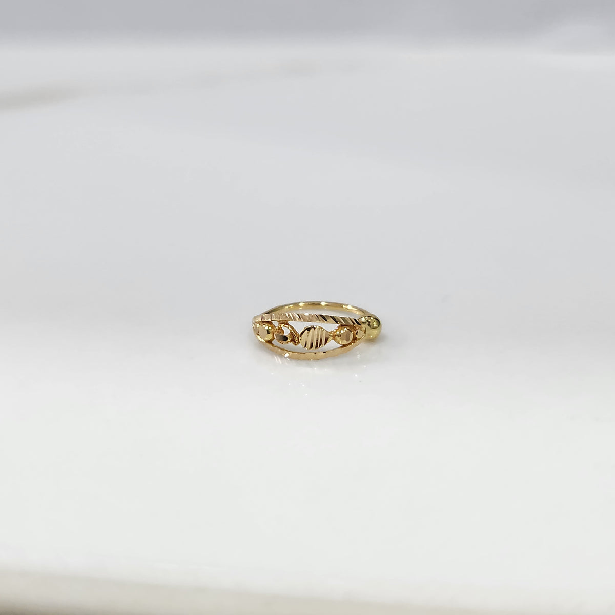 Golden Orbit Gold Nose Ring by Yuvora in 18K gold with cosmic-inspired design displayed on white background