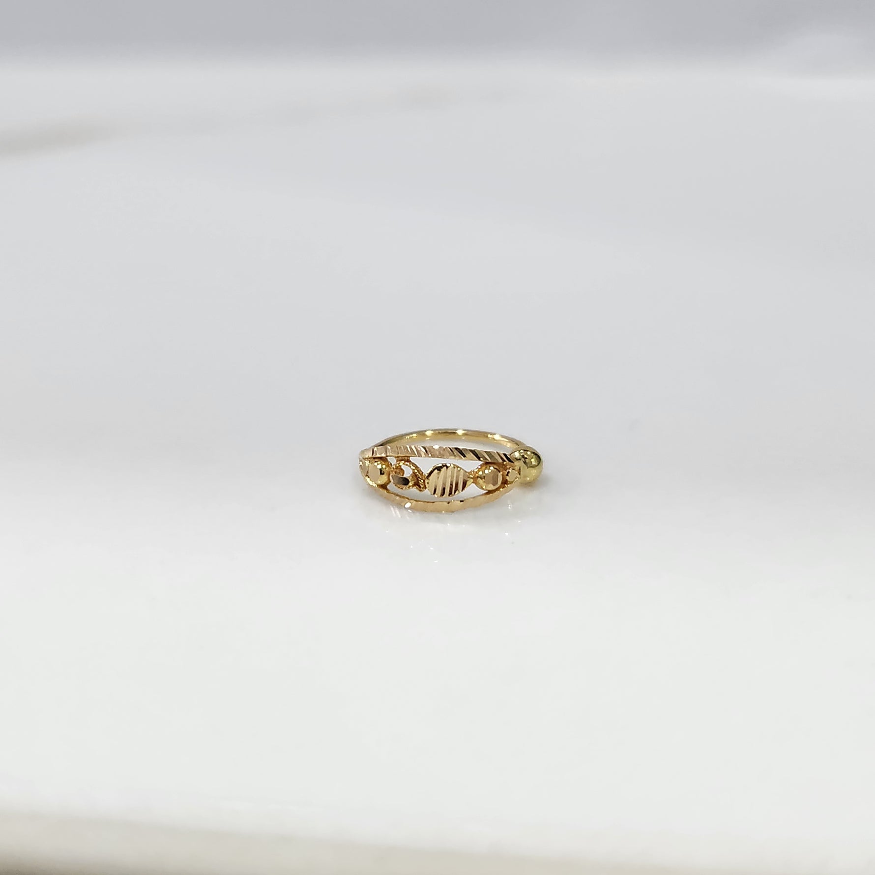 Golden Orbit Gold Nose Ring by Yuvora in 18K gold with cosmic-inspired design displayed on white background