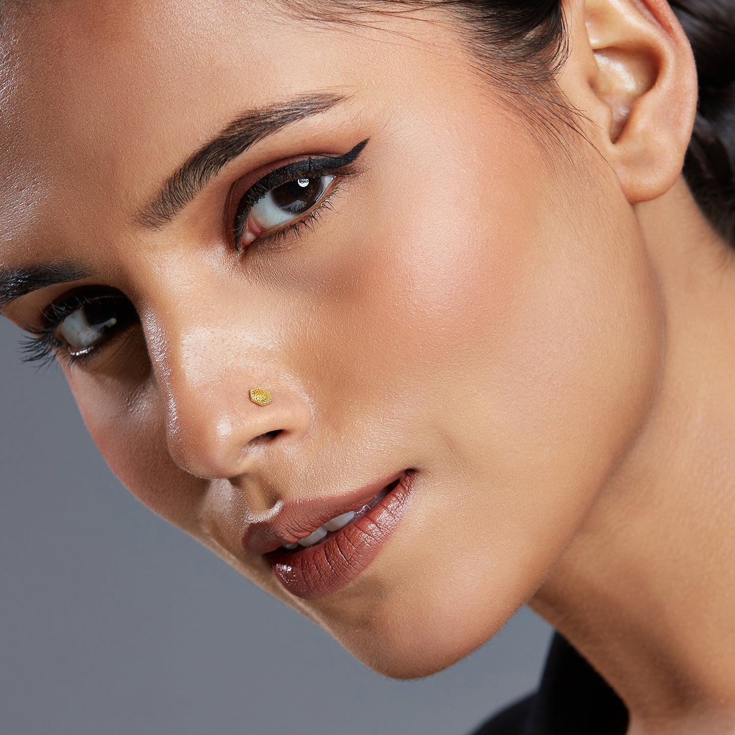 Model wearing Hexa Lattice gold nose pin in 18K gold with geometric hexagon lattice design for a modern and elegant look