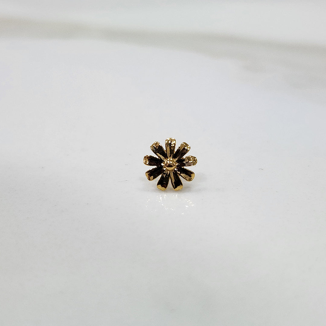 Petal Radiance gold nose pin with floral petal design placed on a flat surface, crafted in 18K gold