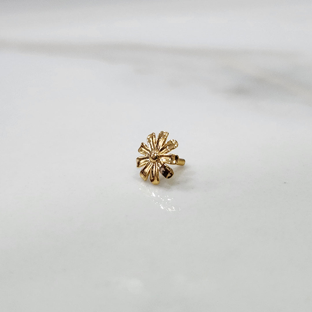 Petal Radiance gold nose pin featuring a daisy-inspired floral design crafted in 18K gold, displayed on a white surface
