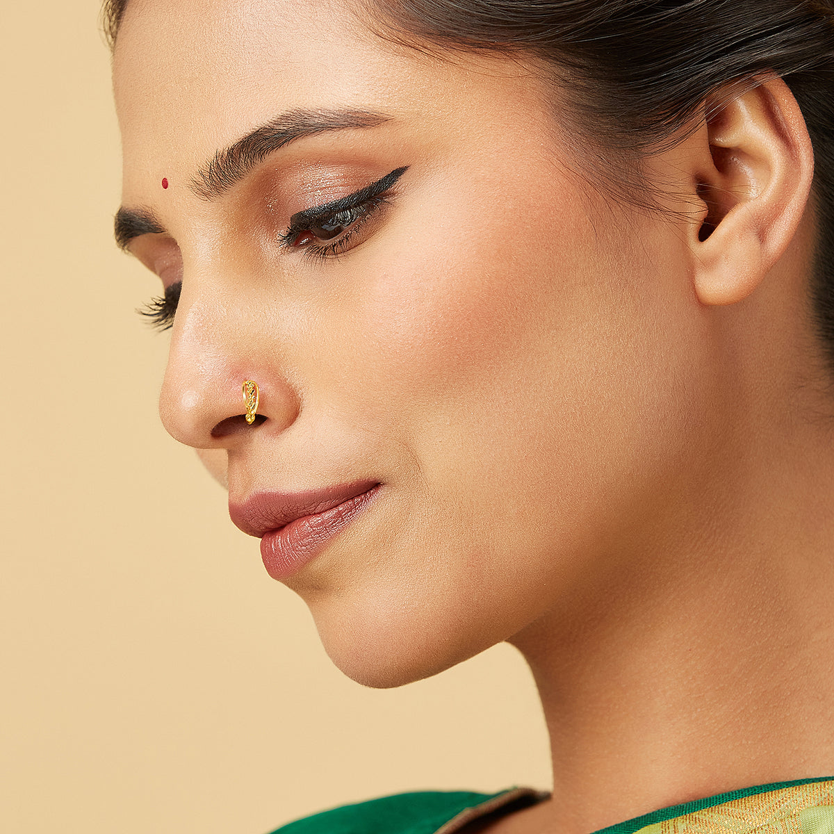 Model wearing Petite Garland Gold Nose Ring in 18K gold with delicate floral design by Yuvora