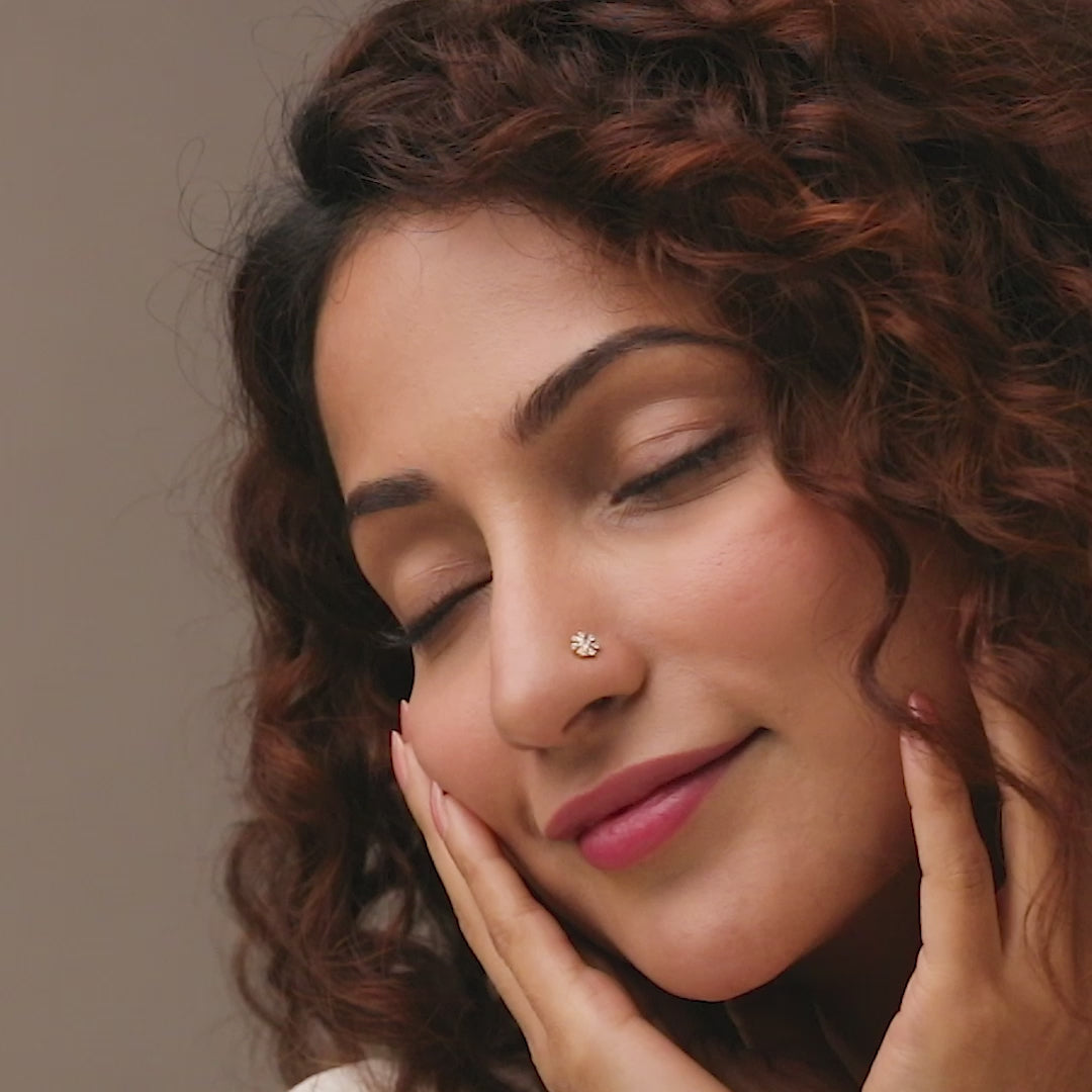 Trending nose pin gold worn on the nose in a close-up portrait, showcasing a modern and stylish everyday look