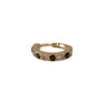 Regalia Aura gold nose ring featuring alternating black and white stones, displayed in a flat side view