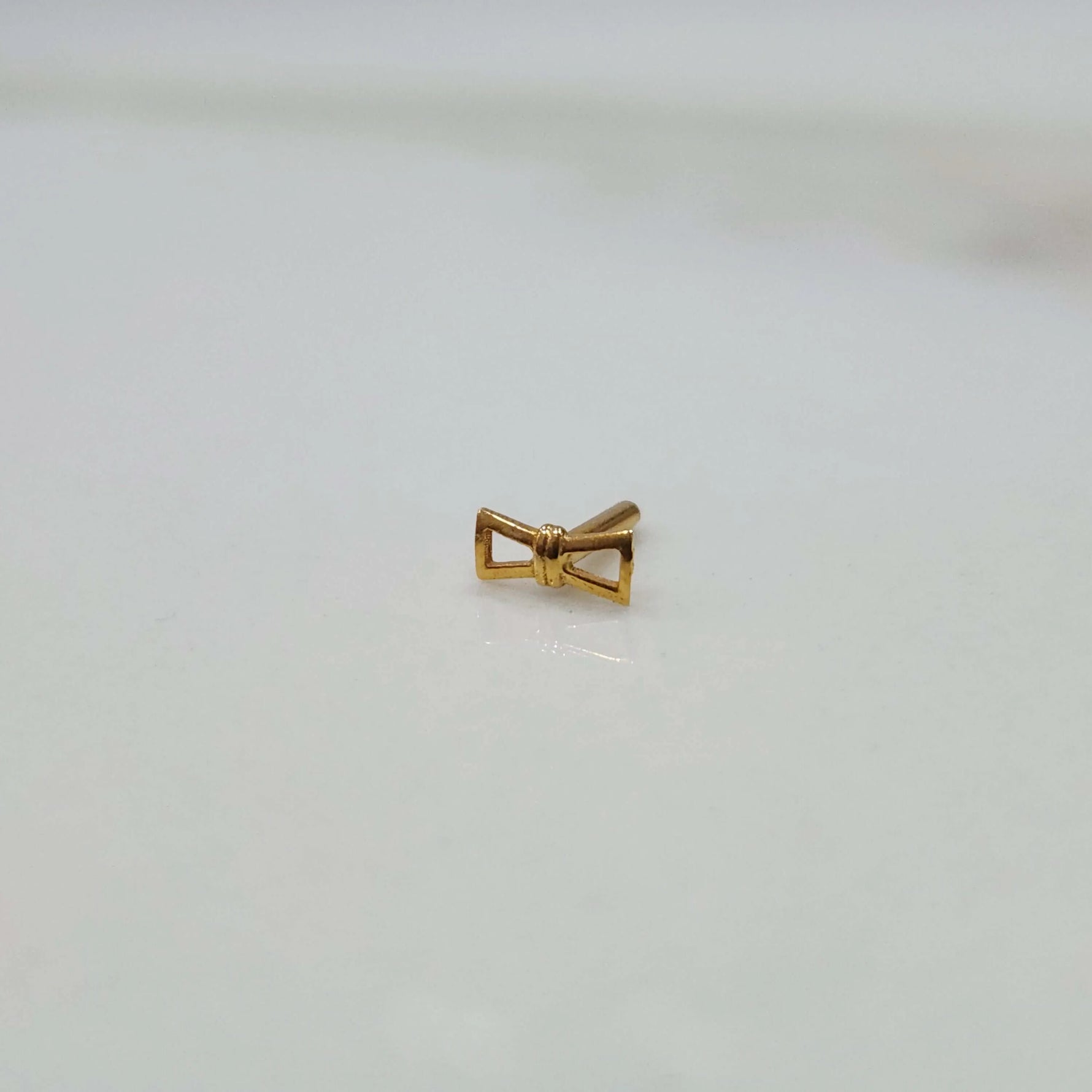 Side view of handcrafted geometric gold nose pin design suitable for women seeking modern indian jewellery style