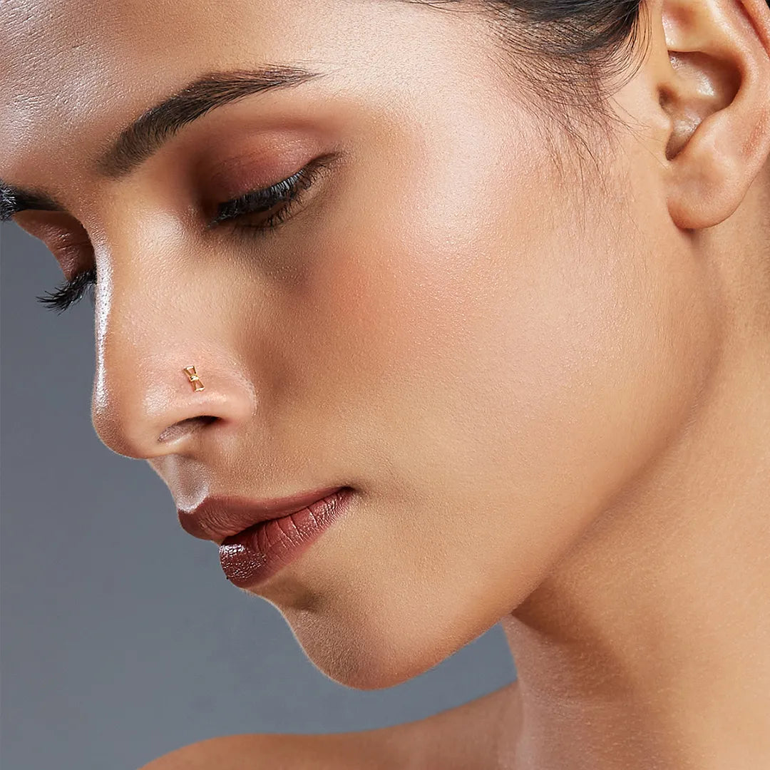 Woman wearing stylish gold nose pin design highlighting contemporary indian gold nose pin look for daily wear
