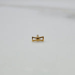 Ribbon Whisper gold nose pin featuring an elegant bow-tie inspired design placed on a flat white surface