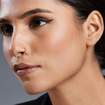 Model wearing Stars Prism gold nose ring in 18K gold, designed with star-shaped details for a cosmic and stylish look