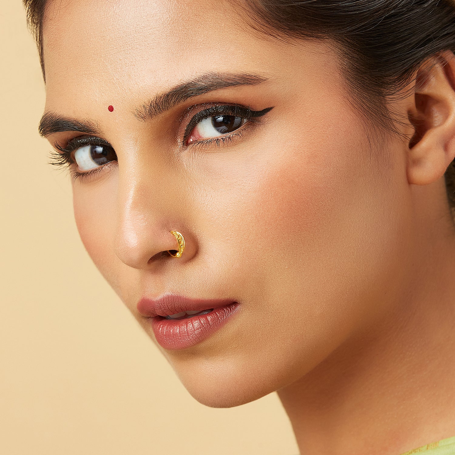 Model wearing Swirl Delight Gold Nose Ring in 18K gold showcasing elegant swirl design for a stylish traditional look