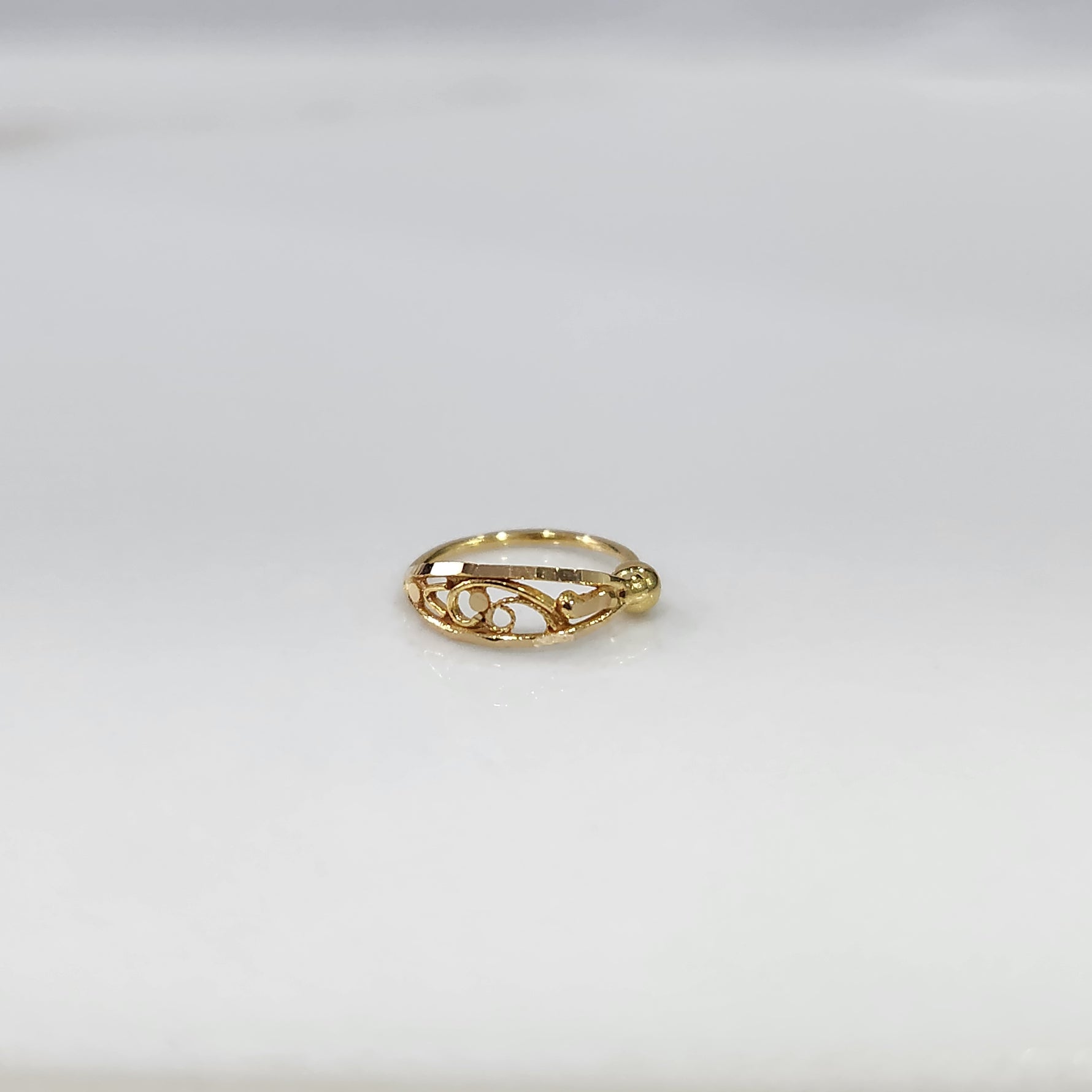 Swirl Delight Gold Nose Ring in 18K gold displayed on a white background with elegant swirl design