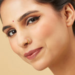 Model wearing Viva Mosaic gold nose pin with geometric engraved design showcasing elegant festive style