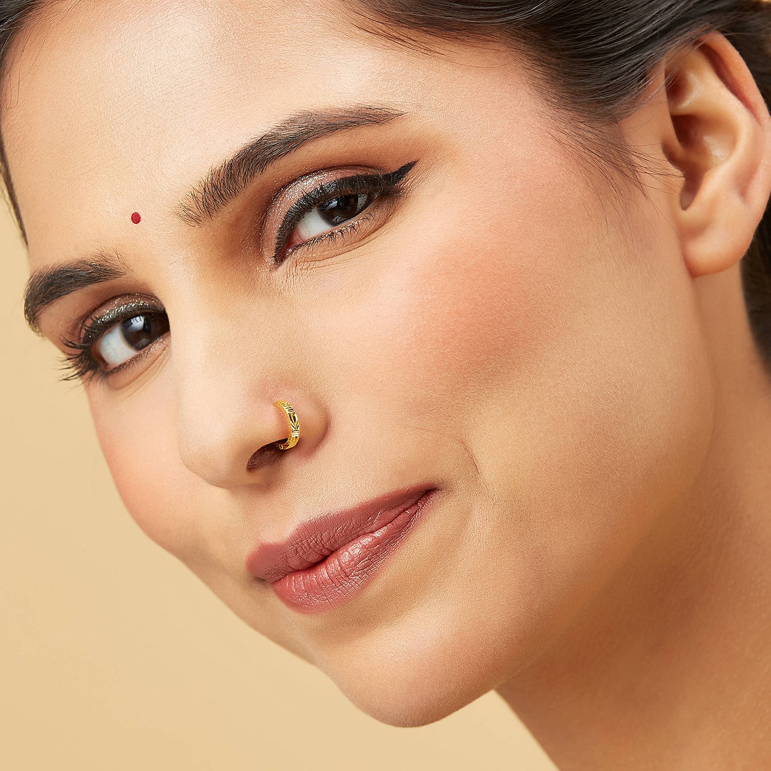 Model wearing Viva Mosaic gold nose pin with geometric engraved design showcasing elegant festive style