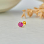 Gold stone nose pin with pink gemstone front view on white background